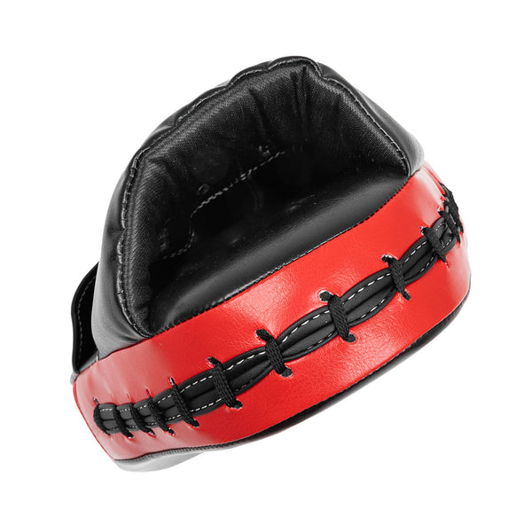A close-up of the SMAI Focus Mitt - Syntec, a black and red leather punching pad with black lacing, designed to hold and absorb punches during training.