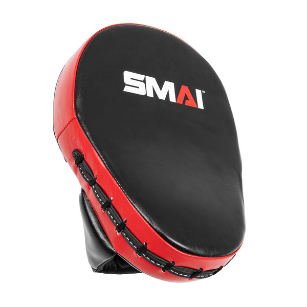 The SMAI Focus Mitt - Syntec is a black and red curved focus pad for martial arts and boxing, featuring the SMAI logo in white and red on the front.