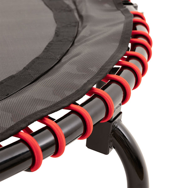 Close-up of the SMAI Folding Rebounder Mini Trampoline 45", highlighting the black frame and red elastic bands connecting the jumping mat—ideal as compact fitness equipment.