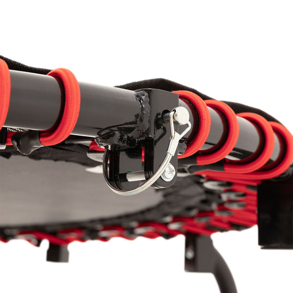 Close-up of the SMAI Folding Rebounder Mini Trampoline 45" showing its black metal frame, red bungee cords, and silver locking pin, with the foldable mat and legs visible in the background.