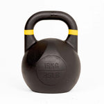 A black SMAI Competition Kettlebell - Fusion Series, featuring yellow stripes near the handle and marked with “16KG” and “35LB” on the front, has a consistent size and a large handle for a reliable grip, and is displayed on a white background.