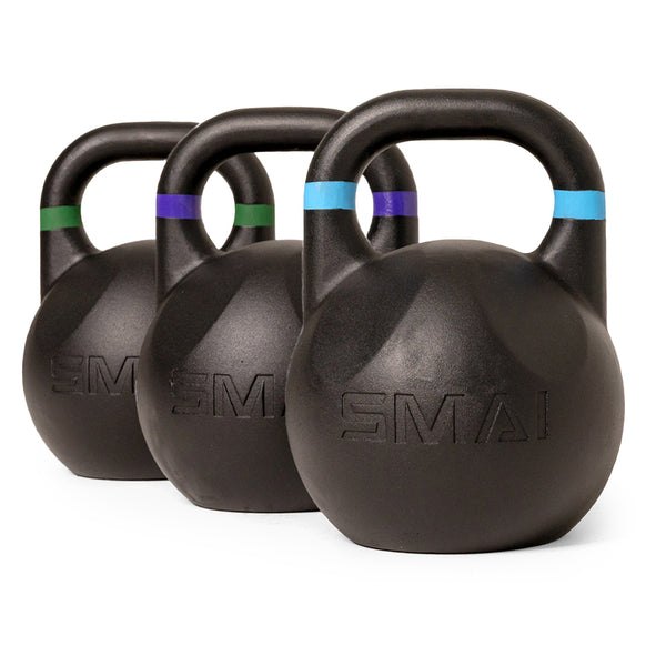 Three SMAI Competition Kettlebell - Fusion Series kettlebells are arranged in a row on a white background. Each black ergonomic kettlebell features a colored band—green, purple, or blue—around the handle and has the SMAI brand name embossed on the front.