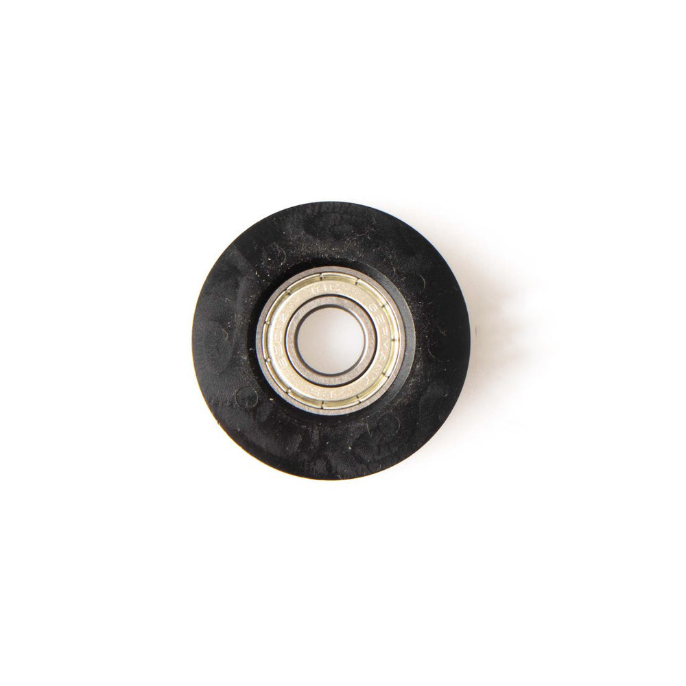 The SMAI Air Ski Machine Spare Part is a black plastic replacement bungee cord pulley with a metal ball bearing center, viewed from above on a white background.