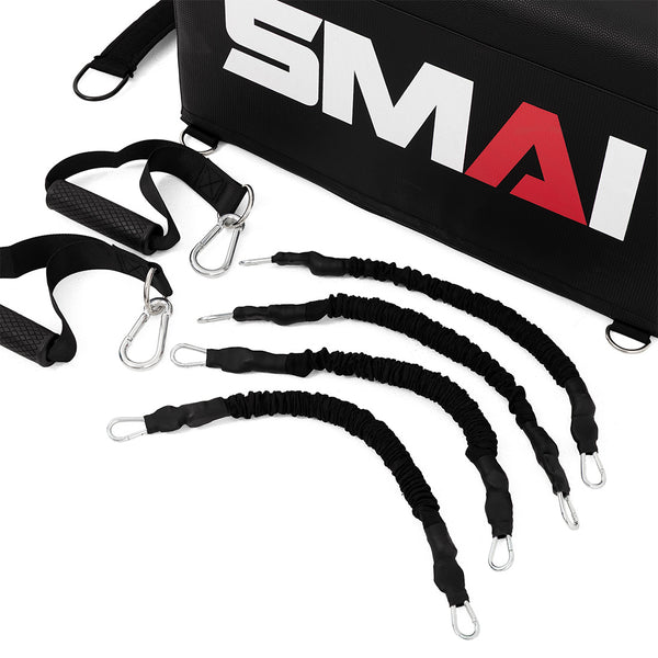 The SMAI Hip Thrust Box with Accessories includes four black resistance bands with metal clips, two black straps with carabiners, and a black equipment bag labeled "SMAI," perfect for hip thrust or glute box workouts.