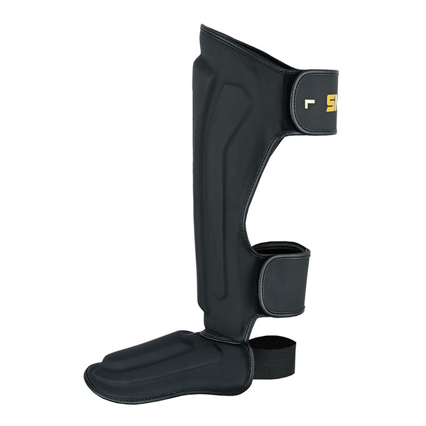 The SMAI PRE ORDER - Gold Series Muay Thai Shin Guards in Black/Gold feature foot protection, adjustable straps, and multi-layered shock absorption for martial arts, shown against a white background.