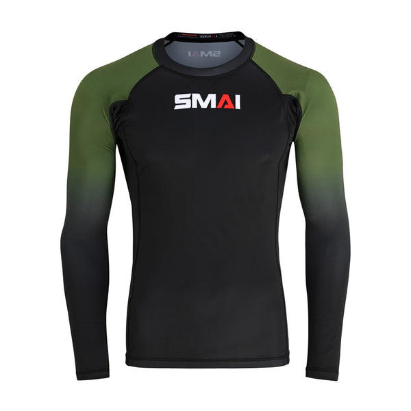 The SMAI Long Sleeve Rash Guard - Olive Green features green sleeves, a black torso, and the white/red "SMAI" logo. Its fitted, stretchy fabric is ideal as a compression shirt for sports or no-gi grappling.