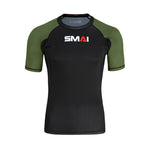 The SMAI Short Sleeve Rash Guard - Olive Green features a black body, olive green sleeves, and the "SMAI" logo in white and red on the chest, shown against a plain white background.