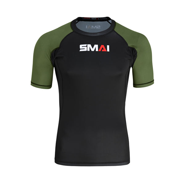 The SMAI Short Sleeve Rash Guard - Olive Green features a black body, olive green sleeves, and the "SMAI" logo in white and red on the chest, shown against a plain white background.