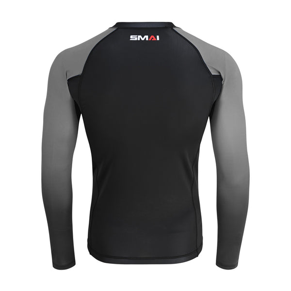 The Long Sleeve Rash Guard - Grey by SMAI features a black body, dark gray sleeves, and "SMAI" branding on the upper back near the neckline.