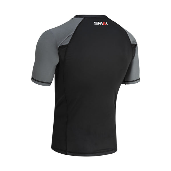 The SMAI Short Sleeve Rash Guard - Grey features black on the back, gray sleeves, and a red and white "SMAI" logo on the upper back. Ideal for no-gi grappling, it's displayed against a plain white background.