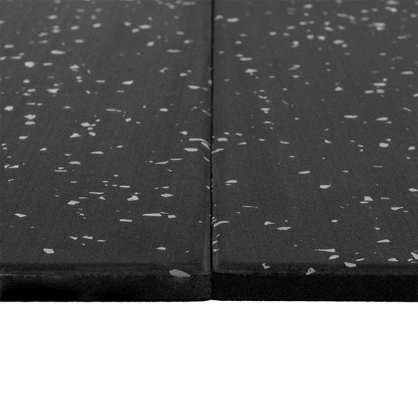Two SMAI Rubber Gym Flooring Tiles - 15mm - Grey Fleck are placed side by side on a white background, showing a close-up of their textured surfaces and joined edges. These durable, non-slip tiles are designed to enhance safety in fitness spaces.