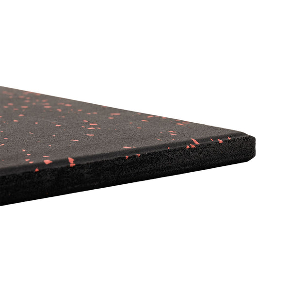 A close-up of the SMAI Rubber Gym Flooring Tile - 15mm - Red Fleck displays its flat, slightly textured black surface with red specks and angled edge, making it a durable choice for gym floors.