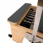 Close-up of the SMAI Pilates - Classical Maple Reformer, showcasing its colored spring resistance system, padded black surface, and adjustable footbar—a premium choice in adjustable Pilates equipment.