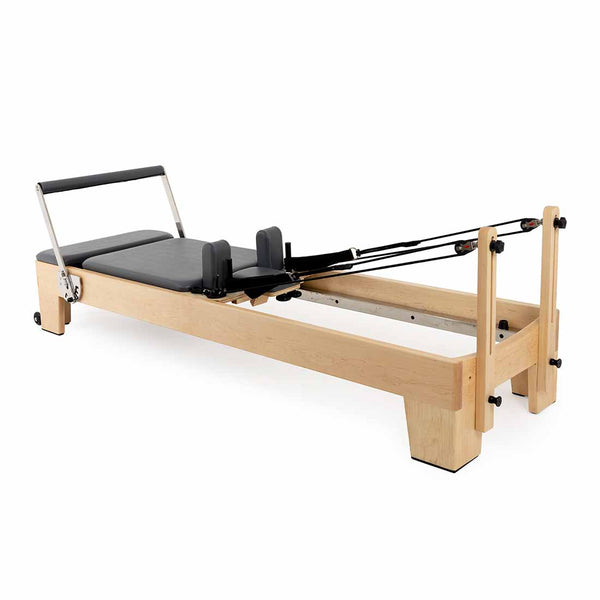 The SMAI Pilates - Classical Maple Reformer features a padded black platform, adjustable headrest, shoulder blocks, foot bar, and resistance straps—an ideal versatile and adjustable commercial Pilates machine.