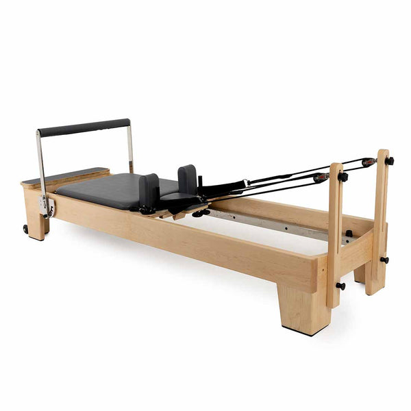 The SMAI Pilates - Classical Maple Reformer features a padded platform, adjustable foot bar, shoulder rests, and black resistance cords—ideal versatile Pilates equipment for a range of workouts.