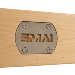 A close-up of the SMAI metal plate, fixed with four screws on the light maple surface of the Pilates - Classical Maple Reformer, showcases its commercial-grade quality for professional pilates studios.