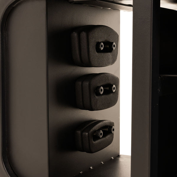 Close-up of three black plastic handles stacked vertically within the SMAI Multi Weight Bench – Dumbbell, Resistance Band and Hand Weight Set, with its metallic frame visible around them.
