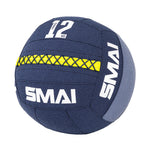 The SMAI Wall Balls - Hybrid Range in navy blue features a yellow stitched stripe, "12 KG" in white on the top panel, durable aramid fibre, and prominent "SMAI" branding—perfect for hybrid strength training.