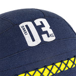 Close-up of a dark blue SMAI Wall Balls - Hybrid Range with "SMAI 03 KG" printed in white and a yellow crisscross design. Built for hybrid strength training, this aramid fibre wall ball offers durability and top performance.