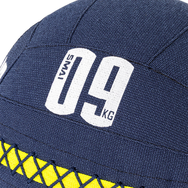 Close-up of a blue SMAI Wall Balls - Hybrid Range surface with "09 KG" and "SMAI" in white, plus yellow crisscross stitching near the base—perfect for hybrid strength training.