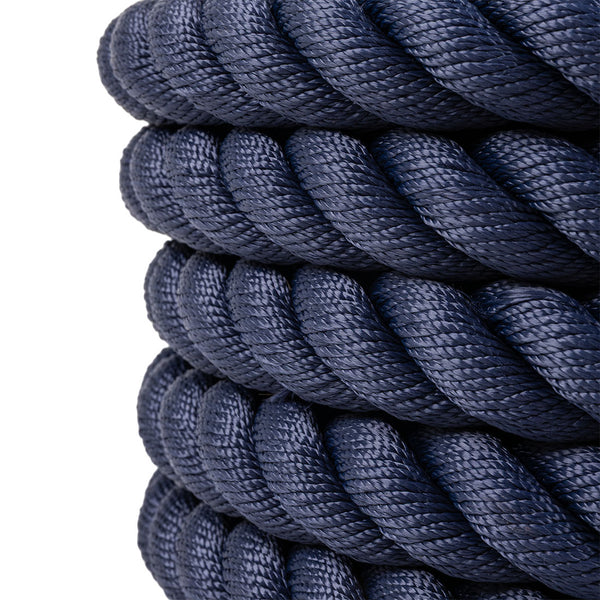Close-up of several SMAI Hybrid Training Power Ropes (15m x 35mm), navy blue and competition-grade, featuring a braided texture and neatly coiled, stacked against a white background.