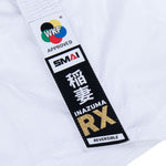 Close-up of the WKF Reversible Karate Uniform - 6oz Premium Kumite Gi by SMAI, featuring a white competition gi adorned with labels showcasing the WKF logo, Japanese kanji, "INAZUMA RX," and "REVERSIBLE" in gold and black text. The textured fabric emphasizes its reversible jacket design, ideal for competitive martial artists.