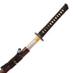 The SMAI High Carbon Steel Katana - Crimson Eclipse is partially drawn from its dark brown scabbard, showing a Damascus folded steel blade, a black handle with white diamonds, and a handguard.