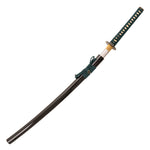 The SMAI Katana - Medium Carbon Emerald features a medium carbon steel blade, black scabbard, green-wrapped handle, decorative guard, and a tied cord near the hilt.