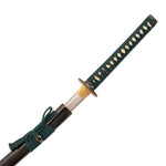 The Katana - Medium Carbon Emerald by SMAI features a medium carbon steel blade, dark green woven handle, gold guard, and comes partially sheathed in a glossy black scabbard with matching green cord wrapping.