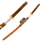 The SMAI Forged Carbon Orange Katana - Sun Emperor features a partially drawn folded steel blade, an ornate orange and gold scabbard with intricate patterns, and a decorative braided cord.