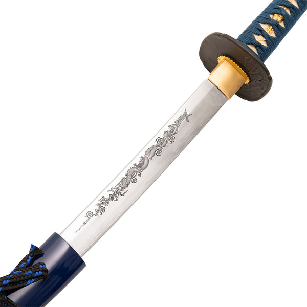 A close-up of the SMAI Katana - Blue Ivy Dragon, a full tang katana with a blue and black wrapped handle and a polished blade featuring an engraved dragon design near the hilt.