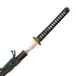 The SMAI Katana - Emerald Dragon features a dark green and gold-wrapped handle, a black scabbard, and a steel blade partially drawn to reveal stunning clay-forged Hamon details.