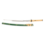 The SMAI Medium Carbon Steel Green Katana - Ancient Dynasty features a shiny curved blade, yellow-patterned handle, and a green and yellow scabbard with gold detailing—an ideal collector’s display piece.