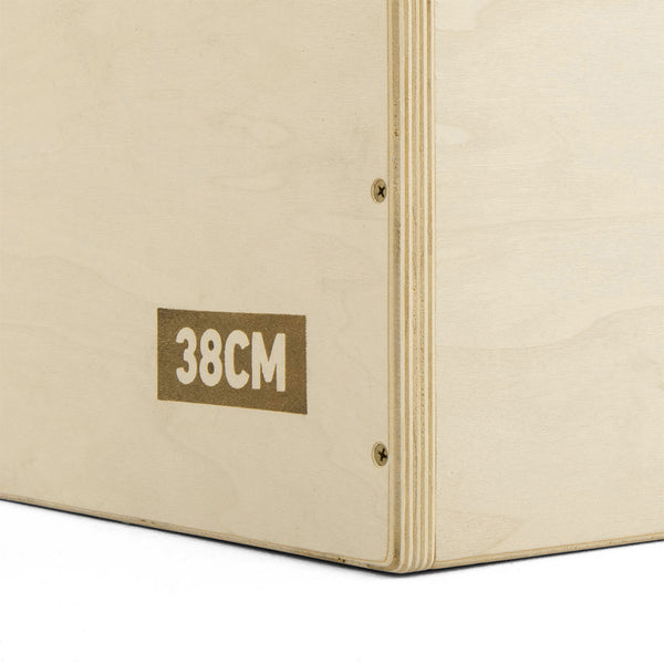 Close-up of a SMAI Jerk Blocks 2.0 plyometric block in light wood, featuring visible corner screws and "38CM" stamped in bold white on the brown side panel.