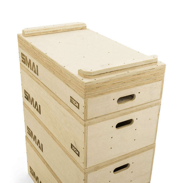 A pair of SMAI Jerk Blocks 2.0, wooden weightlifting blocks with cut-out handles, marked 15cm and 30cm, are neatly stacked and aligned on a white background.