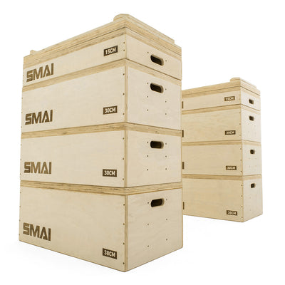 Three SMAI Jerk Blocks 2.0 (Pair) with height markings of 15cm, 30cm, and 38cm are stacked in the foreground, each showing the SMAI logo. In the background, two more blocks with side handles are also visible.