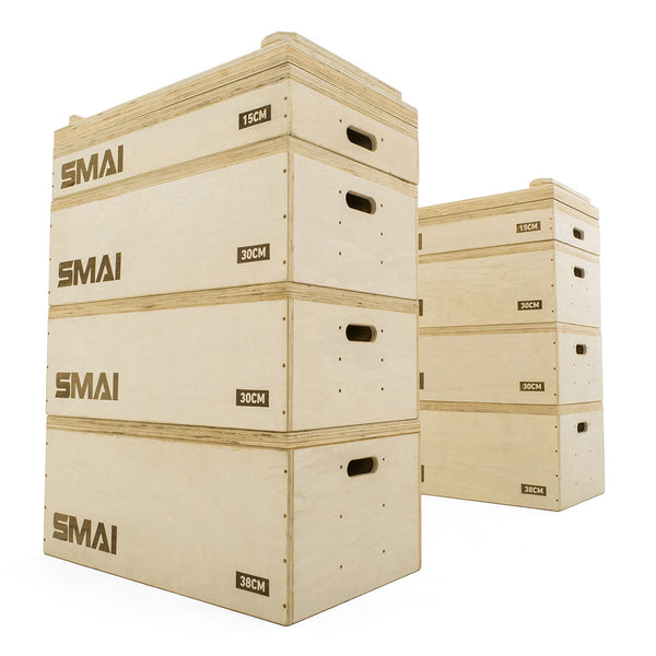 Three SMAI Jerk Blocks 2.0 (Pair) with height markings of 15cm, 30cm, and 38cm are stacked in the foreground, each showing the SMAI logo. In the background, two more blocks with side handles are also visible.