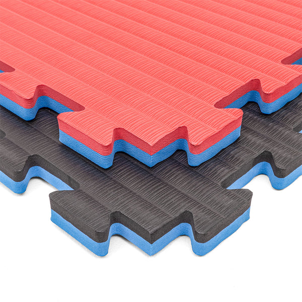 The SMAI Jigsaw Mat - 2cm - Factory Seconds features interlocking red and black EVA mats with blue cores, textured surfaces, zigzag edges for easy fitting, and minor cosmetic imperfections—ideal as gym tiles.