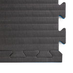 A close-up of two interlocking SMAI Jigsaw Mats—2cm Factory Seconds with cosmetic imperfections—shows their textured, puzzle-like edges joined together, ideal for home gyms or as factory seconds gym tiles.