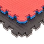 Two SMAI Jigsaw Mat - 3cm - Factory Seconds with cosmetic imperfections are stacked diagonally: the top shows red with a blue and white core, the bottom is black with a gray layer. Both mats feature textured surfaces.
