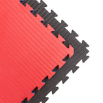 The SMAI Jigsaw Mat - 3cm - Factory Seconds has cosmetic imperfections, features interlocking red and black foam tiles with zigzag edges and a textured surface—ideal for gyms or versatile use.
