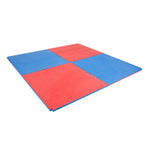 Four SMAI Jigsaw Mats - 3cm - Factory Seconds with cosmetic imperfections form a square with alternating red and blue sections. These gym tiles feature a textured surface and raised edges, offering budget-friendly flooring.
