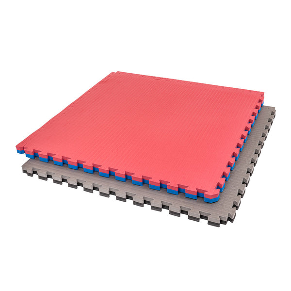 Two SMAI Jigsaw Mat - 4cm - Factory Seconds (with cosmetic imperfections) are stacked: the top is red/blue, the bottom gray/black. Both have puzzle-piece edges and are gym tiles.
