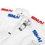 Two white WKF Karate Uniforms (8oz Premium Kumite Gi - Jin) by SMAI, each with red and blue “SMAI” on the shoulders, labels and tags on the collars showing size and brand—ideal for competition use.
