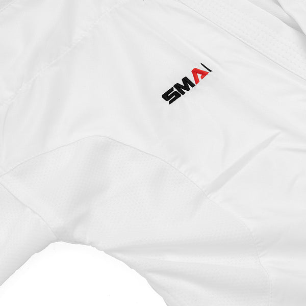 Close-up of the SMAI WKF Karate Uniform Pack - 8oz Premium Kumite Gi - Jin, featuring white textured fabric and black and red embroidered "SMAI" logo, ideal for competition or as a WKF Approved Kumite Gi.