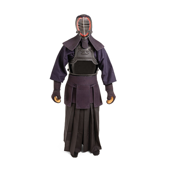 A person stands against a white background wearing the SMAI Kendo Bogu Set, which includes a protective helmet with metal face cage, padded jacket, gloves, chest armor, and pleated skirt.