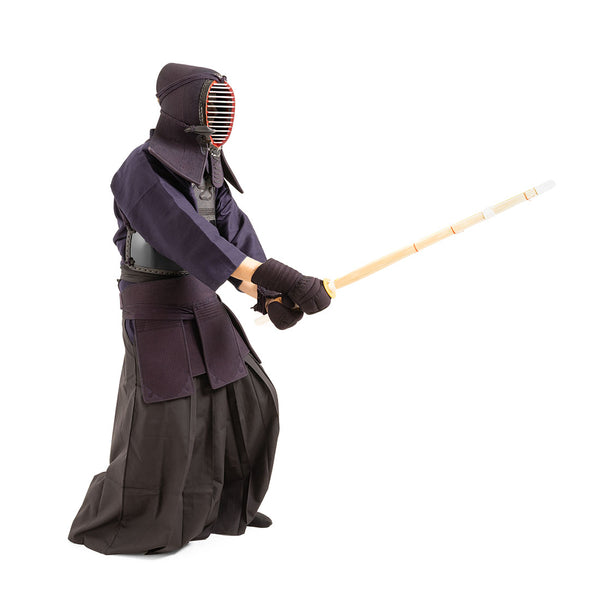 A person in the SMAI Kendo Bogu Set and helmet holds a shinai in a ready stance against a white background, highlighting authentic Kendo equipment.