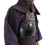 A person wears the SMAI Kendo Bogu Set, featuring a deep blue robe and black chest protector, with parts of the helmet and neck guard visible. The face is partially obscured by the traditional training protection gear.