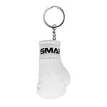 The SMAI Boxing Glove Keyring features a white mini glove with "SMAI" on the wrist strap, attached to a metal keyring—a unique and fun boxing accessory or gift.
