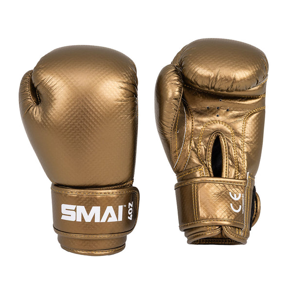 Two gold-colored Essentials Kids Boxing Gloves by SMAI are pictured from different angles—one highlights the SMAI logo on the wrist strap, while the other displays the palm side with a fastening strap. Ideal boxing gloves for kids.